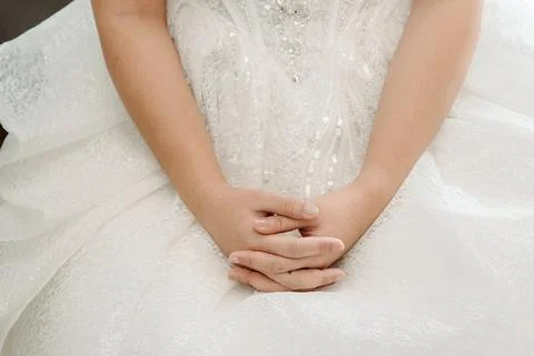 Close-up of Bride's Hands on Sparkly Wedding Dress. Stock Photos