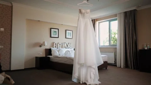 Close-up of the bride's white wedding dress. Huge spacious room. Festive Stock Footage 252196892