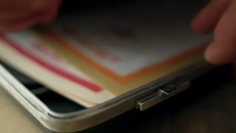 Close up on briefcase lock being opened to reveal top secret folders inside Stock Footage 304281719