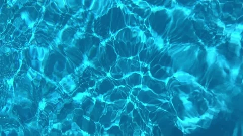Close up of bright blue swimming pool water during daytime with rippling water Stock Footage 315924439