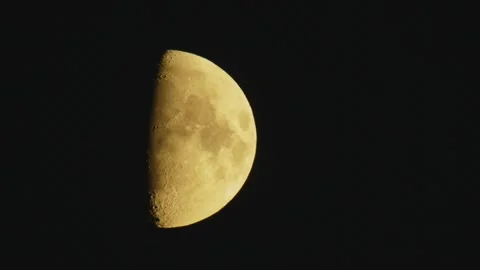 Close-up of a Bright Half Moon with Detailed Craters in a Dark Night Sky, Southe Stock Footage 325468700