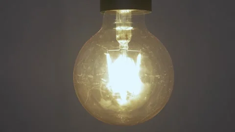 Close up of bright light bulb switching off Stock Footage 240907933