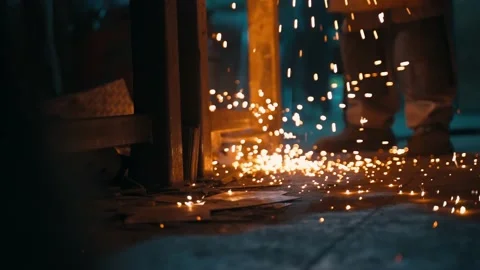 Close-up of bright metallic sparks falling on the floor Stock Footage 224364280