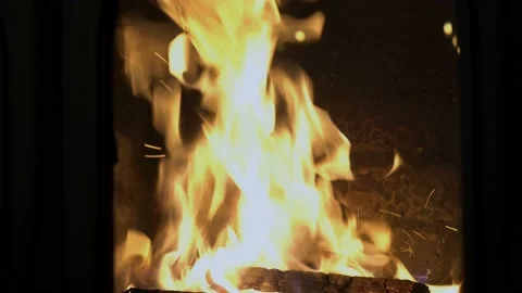 Close-up of a bright orange flame against a brick wall. Concept. Symbol. Stock Footage 124121017