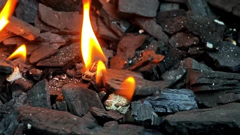 Close-Up of Bright Orange Flame Over Burning Charcoal and Embers, Intense H.. Vídeo Stock 348114003
