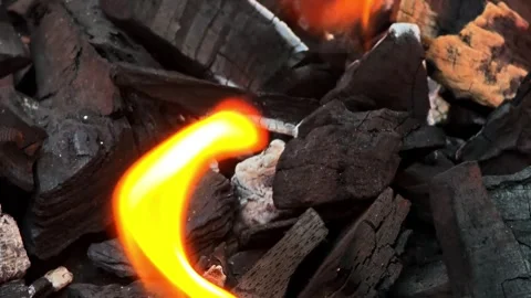 Close-Up of Bright Orange Flame Over Burning Charcoal and Embers, Intense H.. Vídeo Stock 348114005