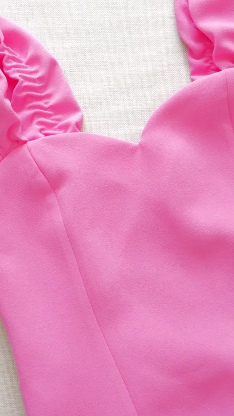 Close-up of bright pink puff sleeve dress fabric detail textile fashion Stock Footage 339160495