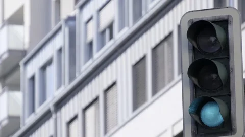 Close-up of a bright red traffic light against a modern building Stock Footage 304963144