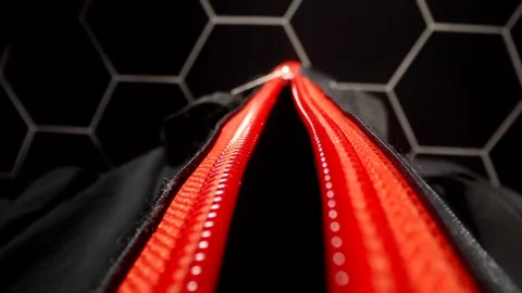 A close-up of a bright red zipper on the black fabric of the bag. A metal slider 스톡 동영상 291638183