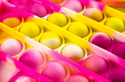 Close-up of a brightly colored Pop it fidget toy. Children's toy Stock Photos