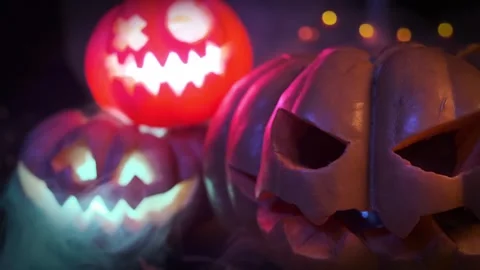 Close-up of brightly flashing three pumpkins sharply approaching shot Stock Footage 251823521