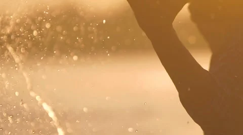 Close-up of brightly glittering splash of water made by a playful couple Stock-Footage 68076345