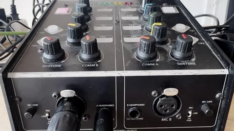 Close-up of a broadcast intercom control unit with comm knobs, sidetone dials Stock-Footage 336709803