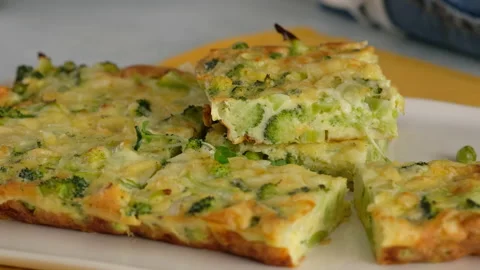Close-up. Broccoli frittata sprinkled with microgreens on a plate. Italian Stock Footage 152486847