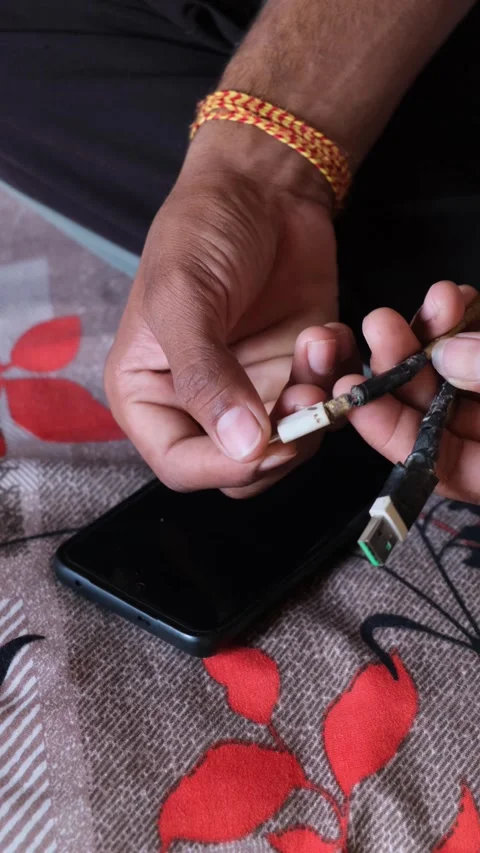 Close-up of Broken and Taped USB Charging Cable with Smartphone Video stock 331354346