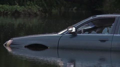 Close up of broken car drowned in lake during day time, New Orleans, US Video stock 132396067