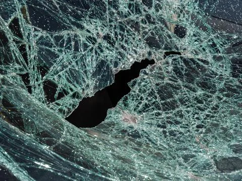 Close-up broken car windshield. Broken and damaged car. Stock Photos