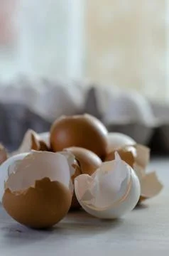 Close up of broken egg shells on wooden background. Stock Photos