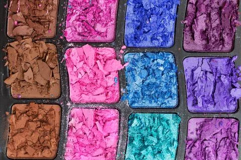 Close-up of broken eye shadow. Makeup palette. Abstract background for beauty Stock Photos