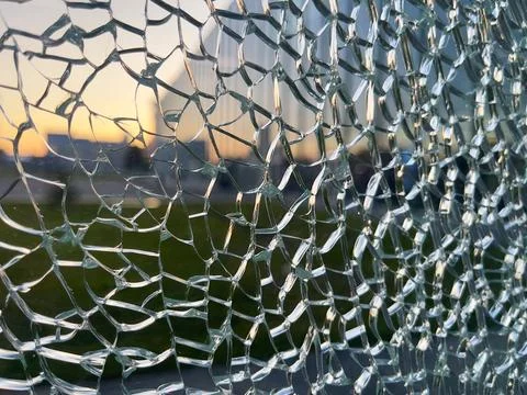 A close-up of the broken glass in the window. Stock Photos