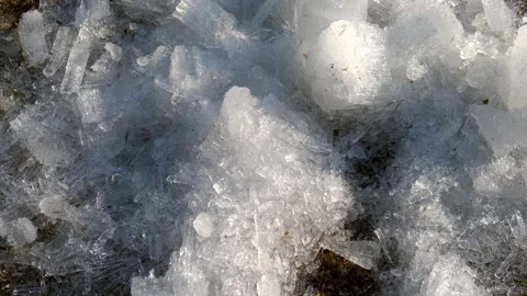 Close-up broken ice crystals on the land in spring day shining on sun. Video stock 311860541