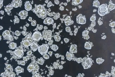 Close up of broken ice in flowing river Stock Photos