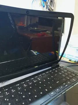 A close-up of a broken laptop with its plastic screen frame completely detached, Stock Photos