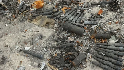 Close-up of broken large-caliber bullet cartridges on the ground Stock-Footage 182905169