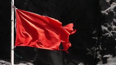 Close-up of broken red flag moved by the wind. Slow motion. Stock Footage 71798493