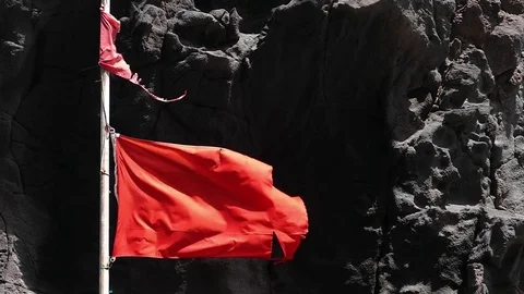 Close-up of broken red flag moved by the wind. Slow motion. Video stock 71798497