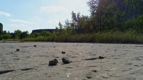 Close-up of broken road amid cooling tower for nuclear reactors of Chernobyl NPP Stock Footage 124324177