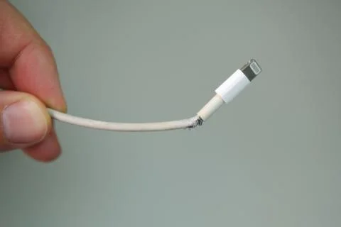 Close-up of broken smartphone's charger cable Stock Photos