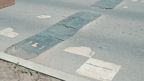 Close-up of broken speed bumps and road markings on the road, designed to slow Stock Footage 339090662