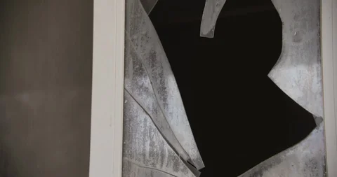 Close Up of Broken Window Tilt Down Stock Footage 89942097