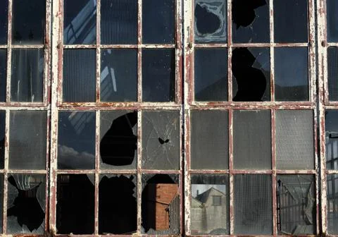 Close up of broken windows in a derelict building. Stock Photos