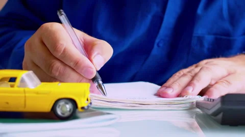 Close up of broker hands writing data and signing vehicle registration contract Stock Footage 337671160