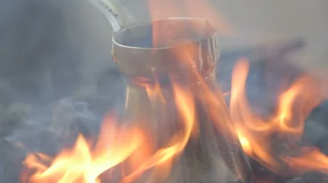 Close-up of bronze coffee maker standing on fire Stock Footage 7769204