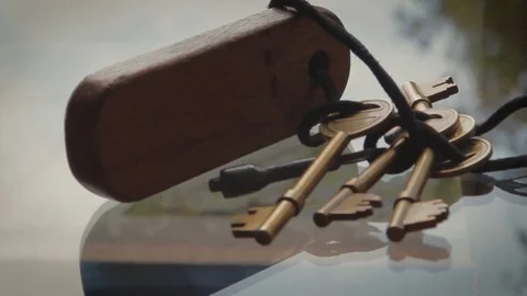 Close Up on Bronze Keys tied with string to wooden key fob 動画素材 73056521