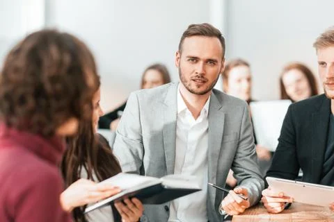 Close up. brooding entrepreneur sitting at office Desk Stock Photos