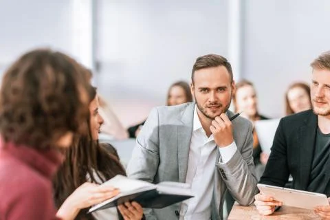 Close up. brooding entrepreneur sitting at office Desk Stock Photos