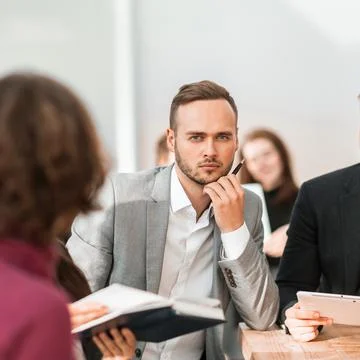Close up. brooding entrepreneur sitting at office Desk Stock Photos