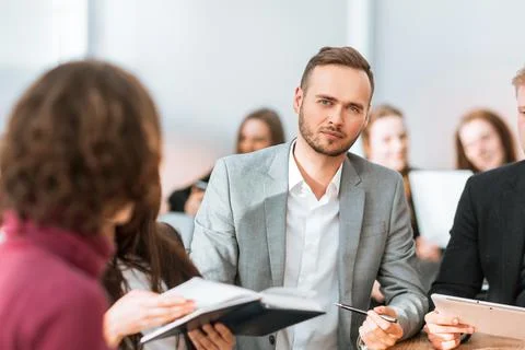Close up. brooding entrepreneur sitting at office Desk Stock Photos