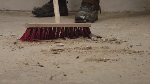 Close-up of broom sweeping dust on concrete floor Stock Footage 328318951