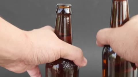 Close up of brown beer bottles in a man's hands Stock Footage 68768650