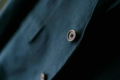 Close-up of a brown button on a navy blue men's blazer. Fotos Stock