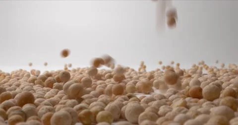 Close up of brown chickpeas are falling onto white surface. Concept of Healthy Video stock 148616266