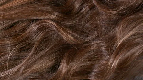 Close-up brown curly hair texture, female long hair background in slow motion Stock Footage 282426525