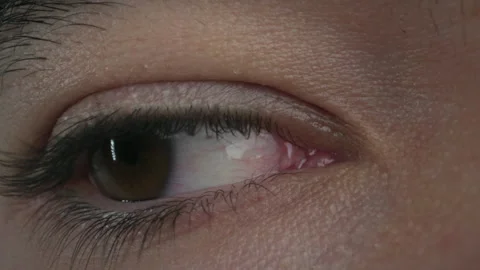 Close-up of a brown eye blinking 스톡 동영상 307711748