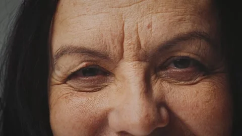 Close-up brown eyes sight senior elderly mature woman looking at camera Stock Footage 342249911