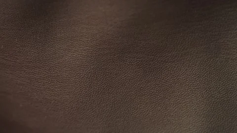 A close-up of the brown faux leather texture. The detailed surface of the faux Stock Footage 334943861